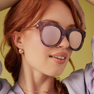 on model - female wearing diff eyewear disney princess rapunzel sunglasses marbled floral & rose pink angled view