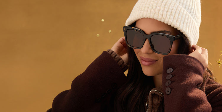 Two young women standing out into the horizon wearing reflective DIFF aviator sunglasses heading out to a workout